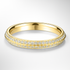 Yellow gold wedding ring with diamond accents on a light grey background