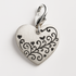 Silver satin heart-shaped pendant with black engraving on a light grey background