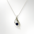 Silver pendant with sapphire and diamond on a white background