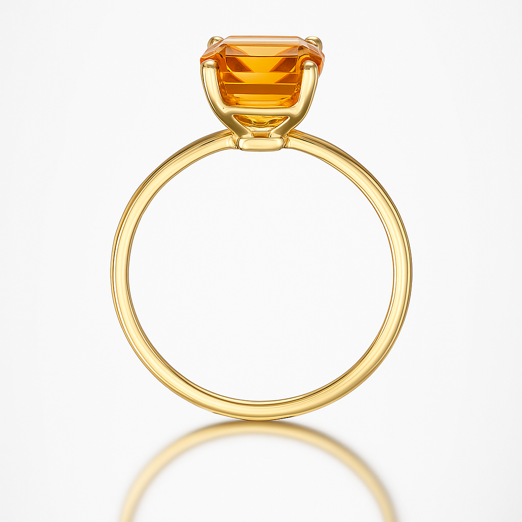Gold ring with a citrine orange gemstone on a white background