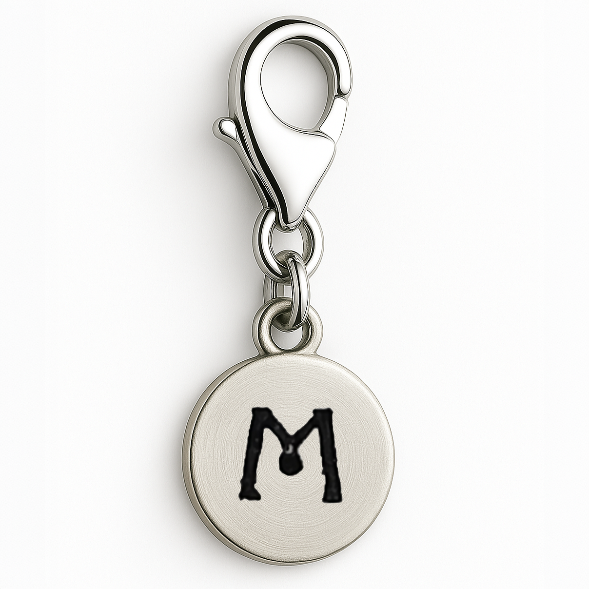 Silver charm with letter 'M' on a white background