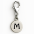 Silver charm with letter 'M' on a white background