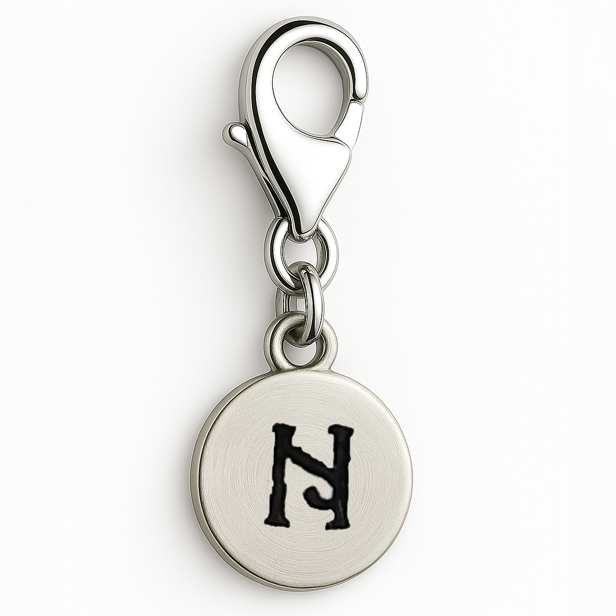 Silver charm with a black letter 'N' on a white background