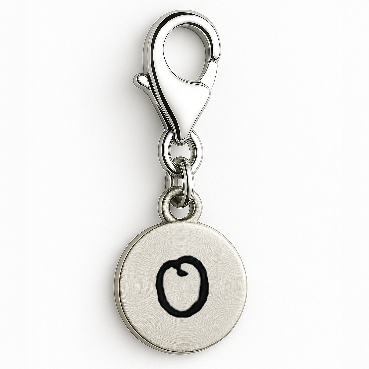 Silver charm with a round tag and black O on a white background