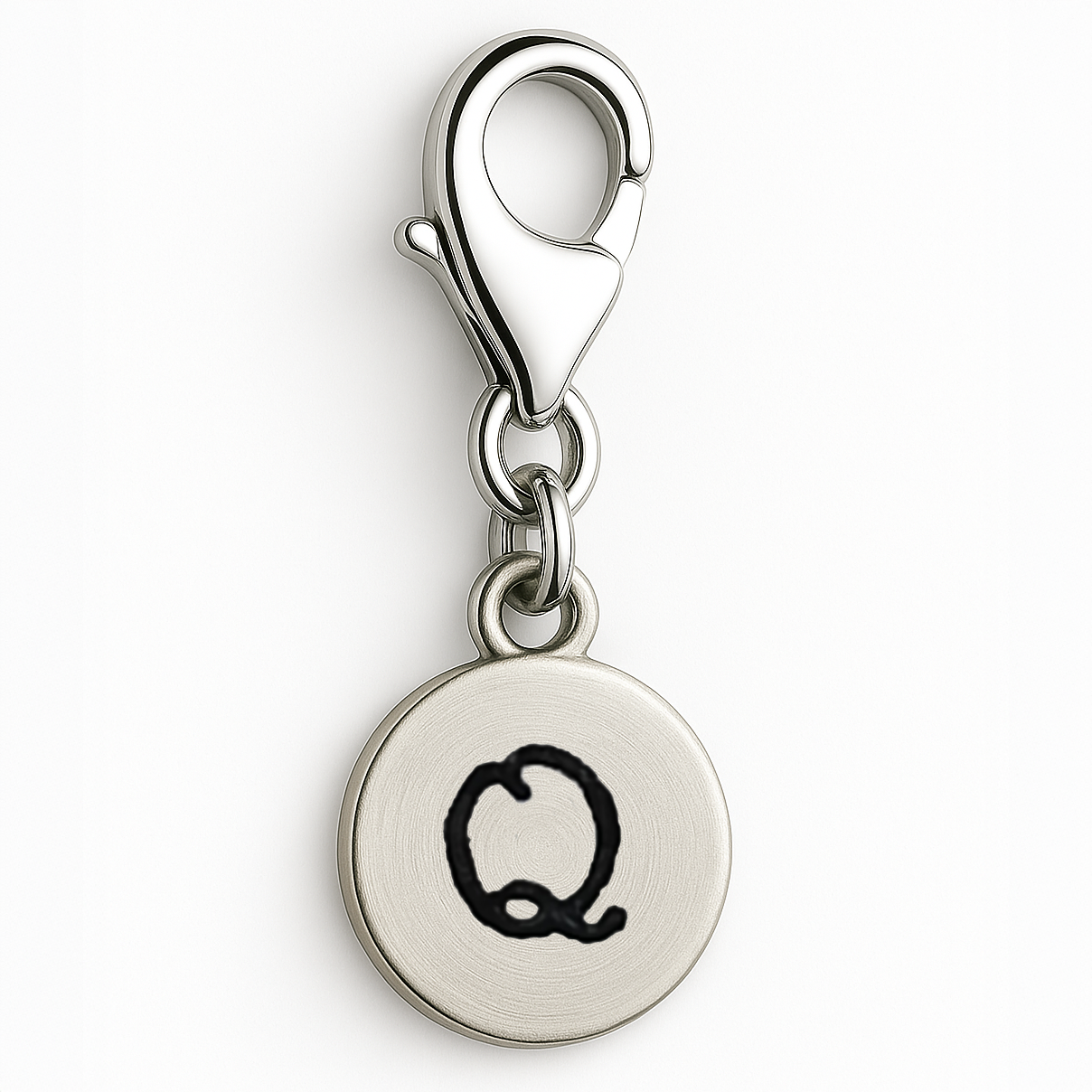 Silver charm with letter 'Q' on a white background