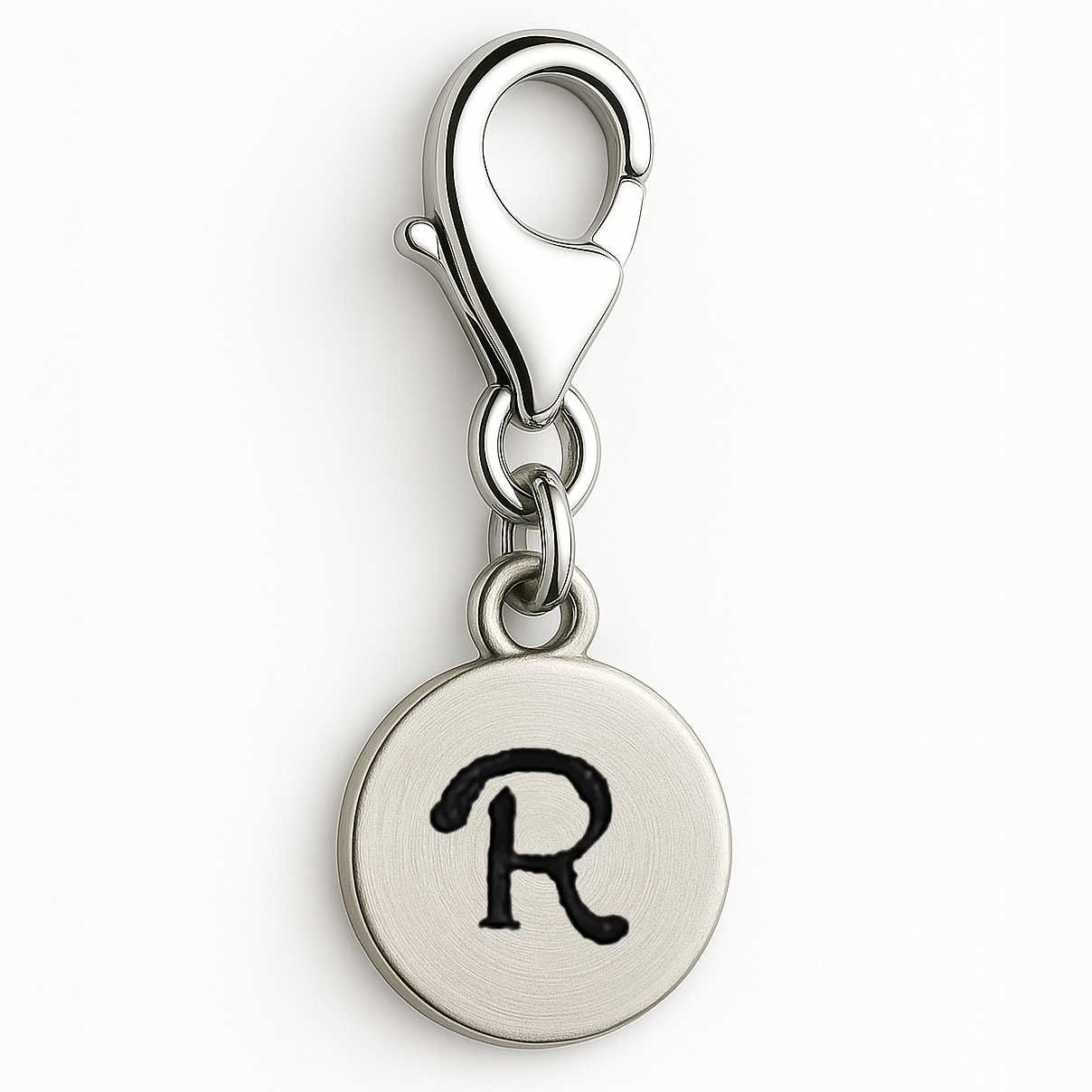 Silver charm with letter 'R' on a white background