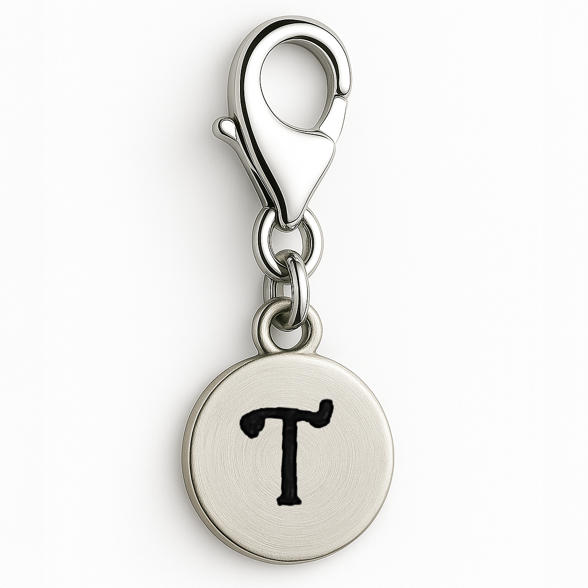 Silver charm with letter 'T' on a white background