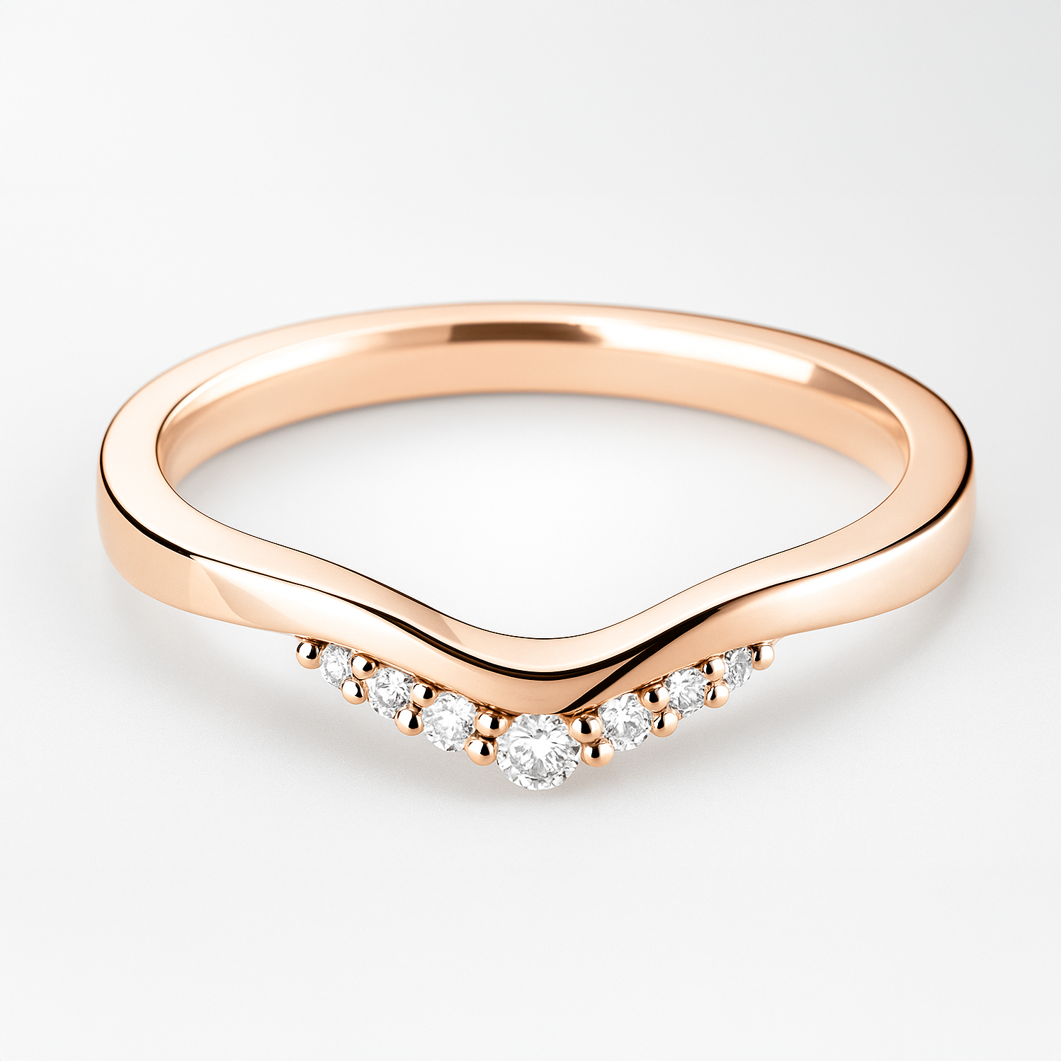 Rose gold ring with diamond accents on a light background