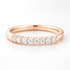 Rose gold wedding ring with diamonds on a white background