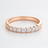 Rose wedding  gold ring with diamonds on a light grey background