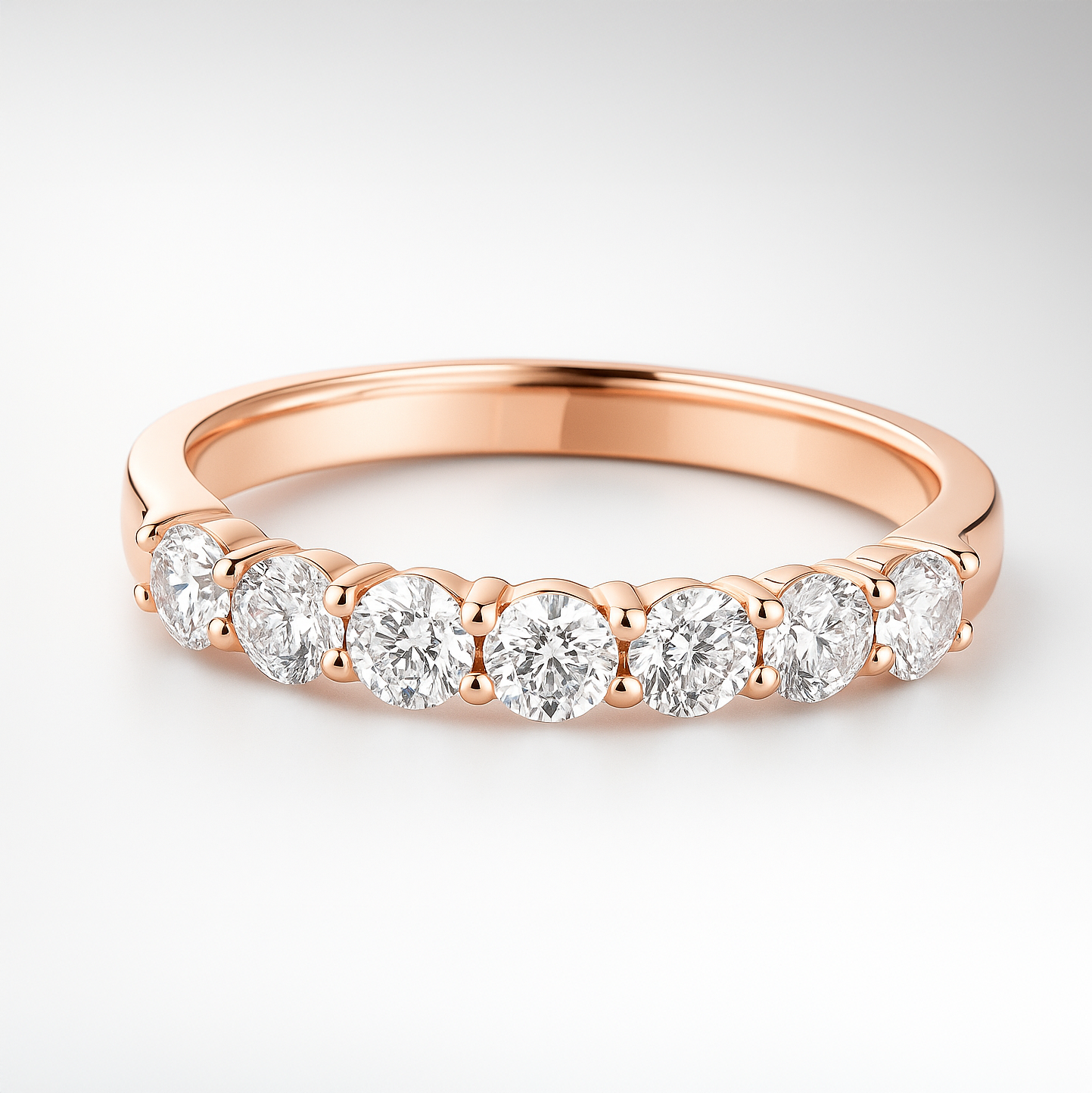 Rose gold wedding ring with diamonds on a light grey background
