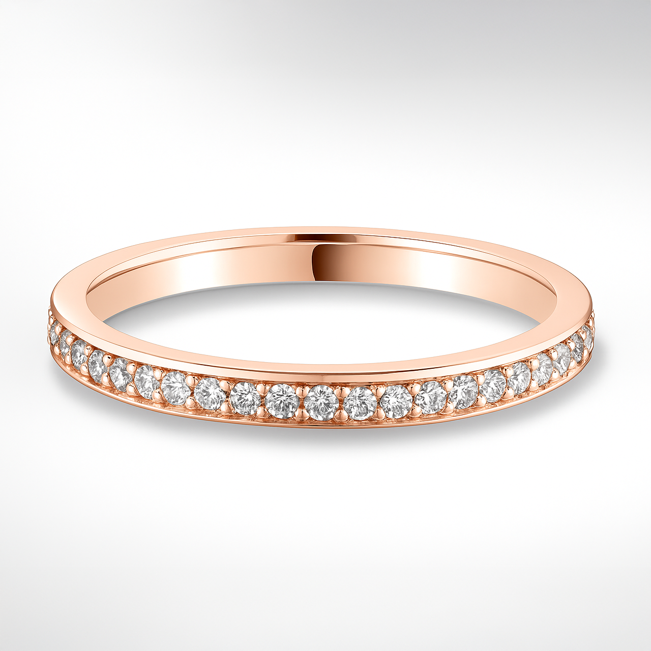 Rose gold ring with diamonds on a light grey background