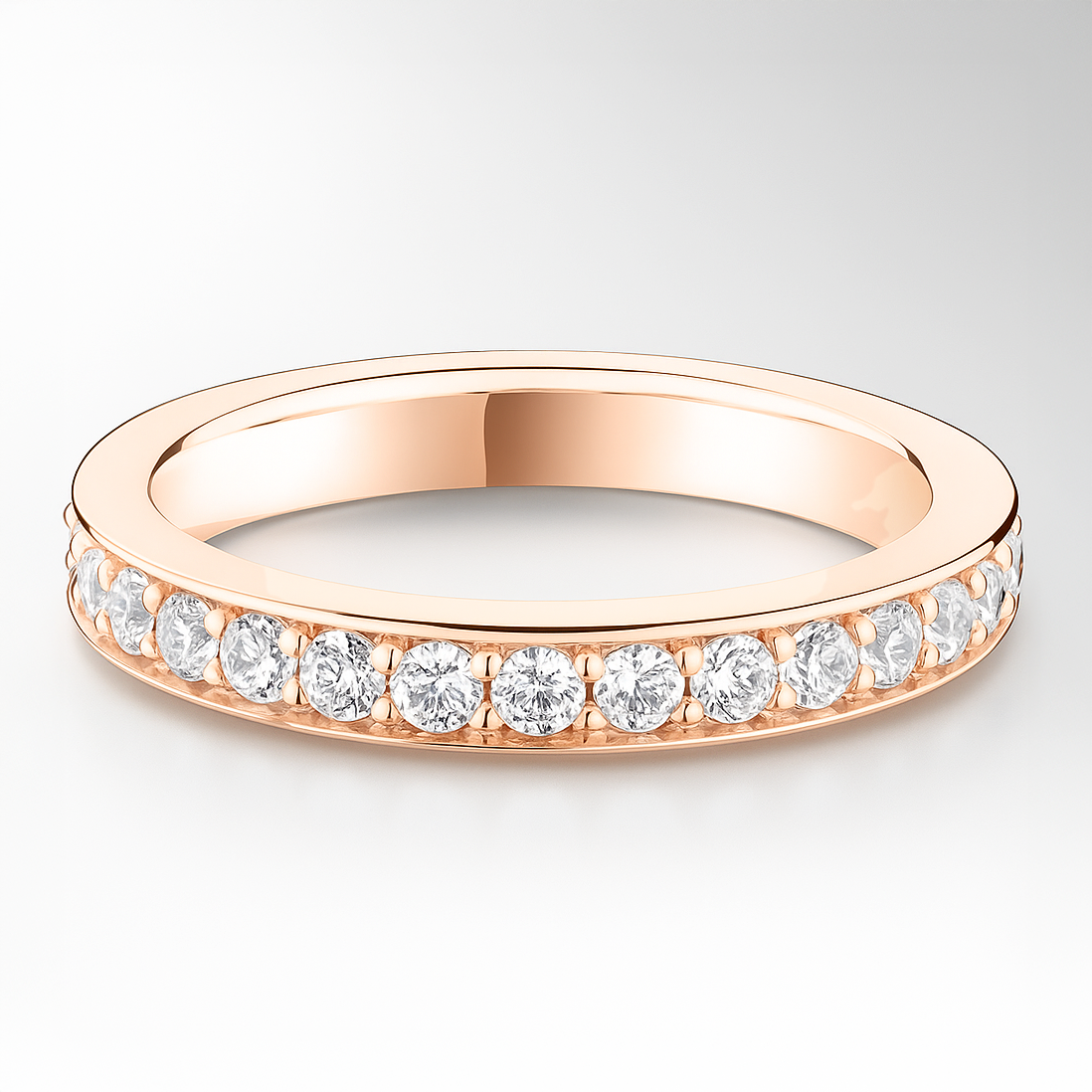Rose gold ring with diamonds on a light grey background