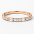Rose gold ring with diamonds on a white background
