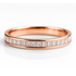 Rose gold ring with diamond accents on a white background