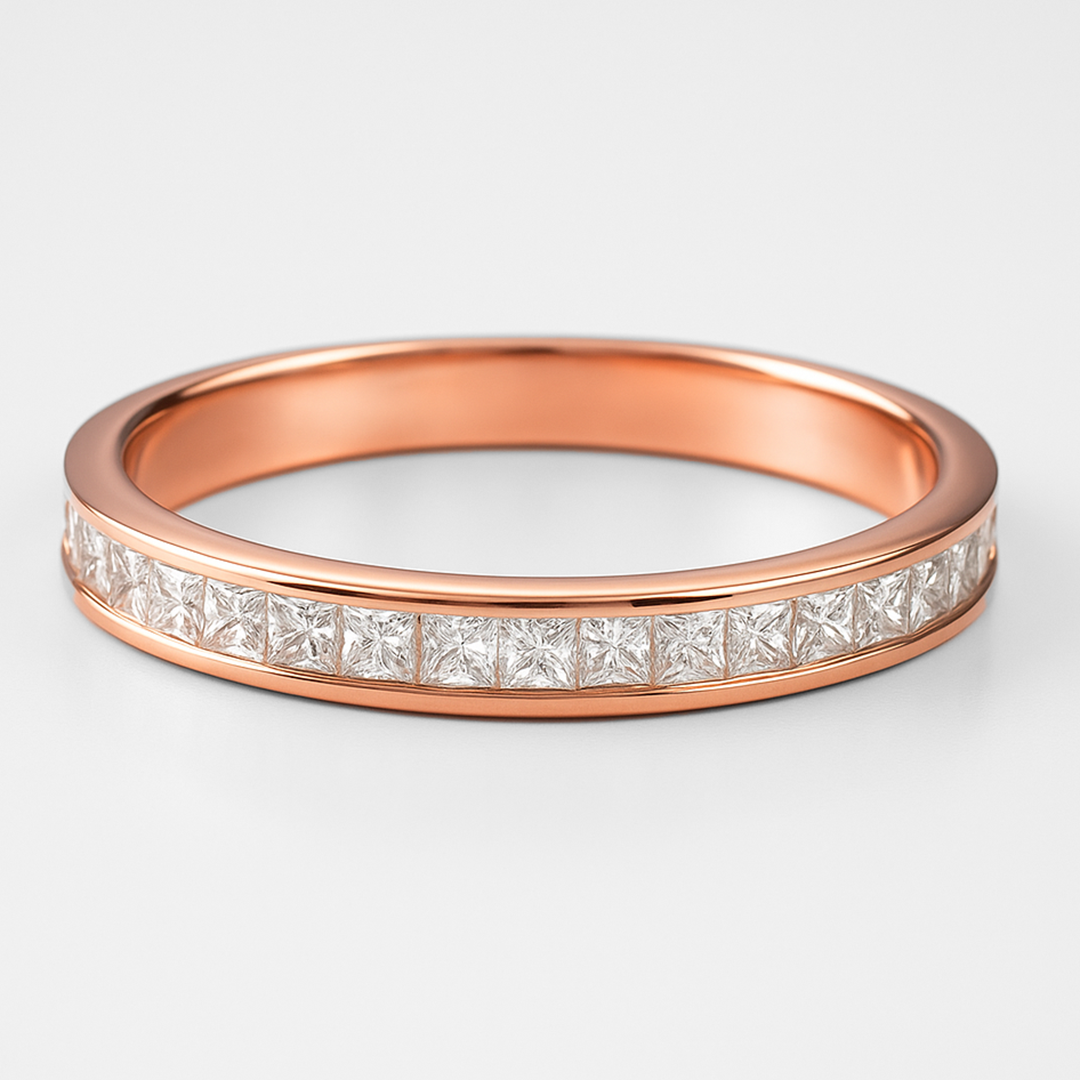 Rose gold ring with diamond stones on a light grey background