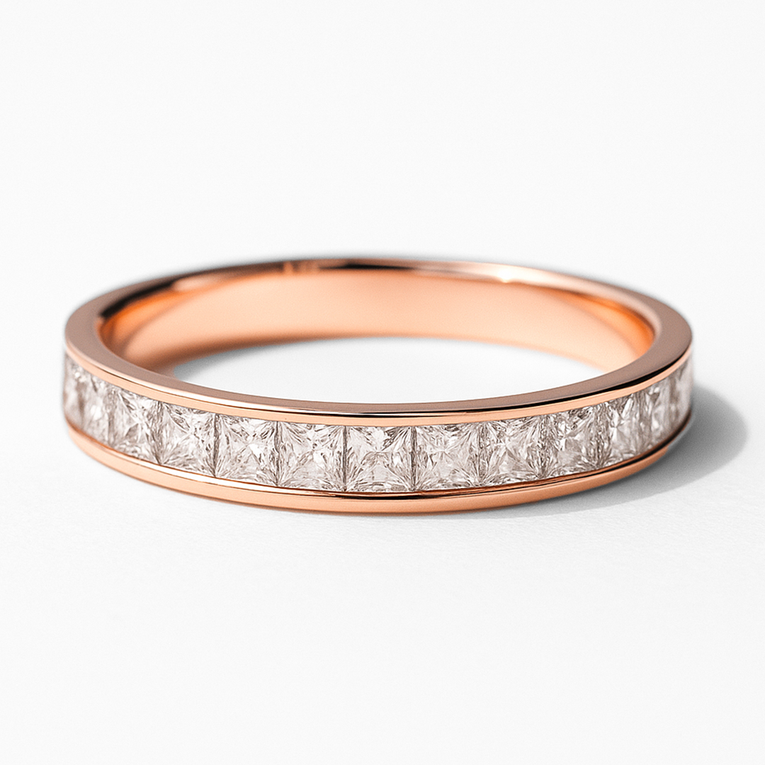 Rose gold ring with diamond accents on a white background