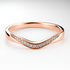 Rose gold ring with diamond accents on a light background