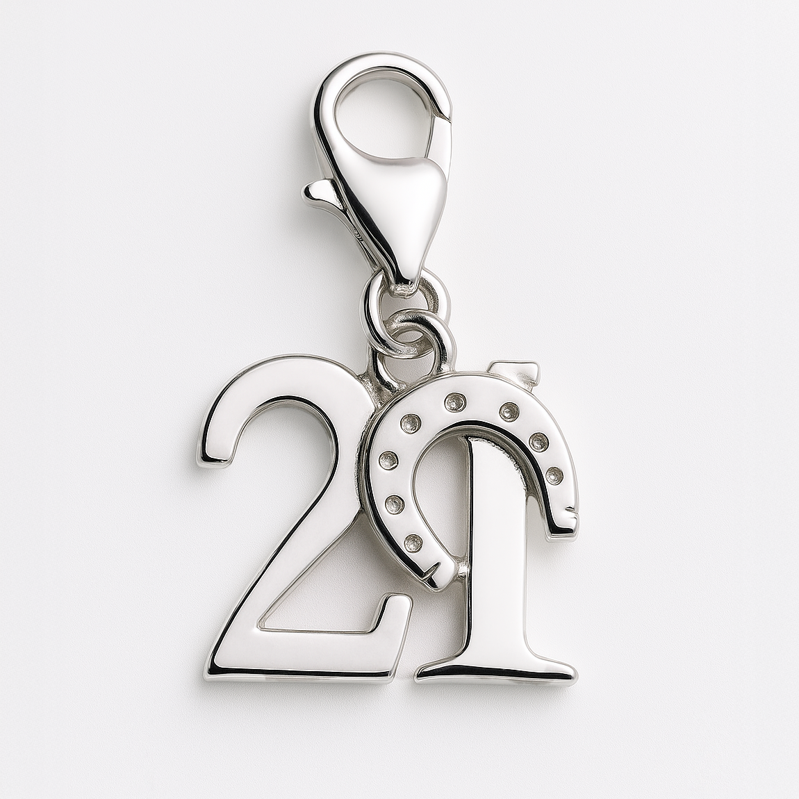 Silver pendant with number '21' and horseshoe design on a white background