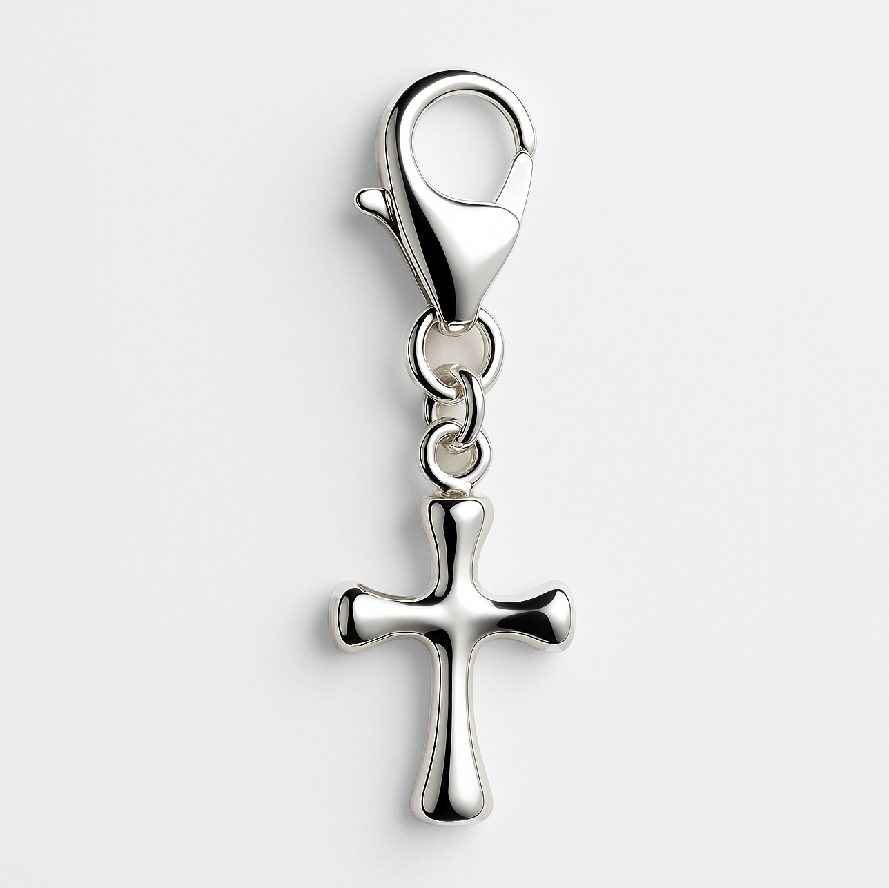 Silver cross pendant with a lobster clasp on a light grey background