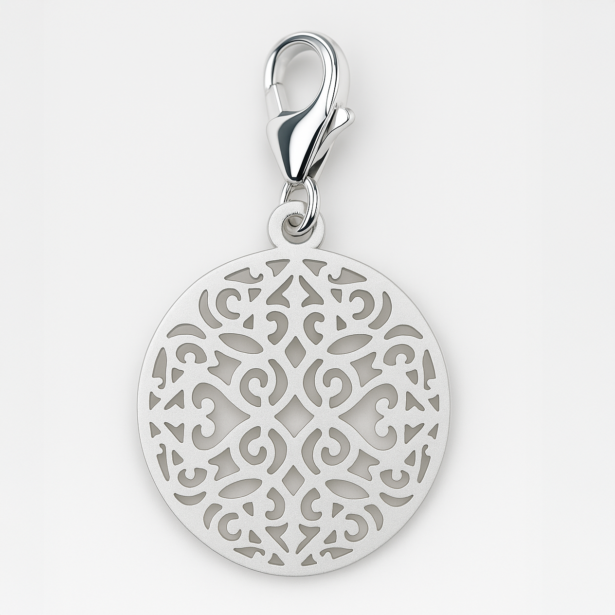 Silver pendant with intricate design on a light grey background