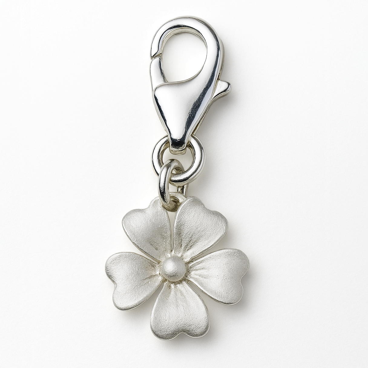 Silver flower charm with a clasp on a white background