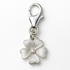 Silver flower charm with a clasp on a white background
