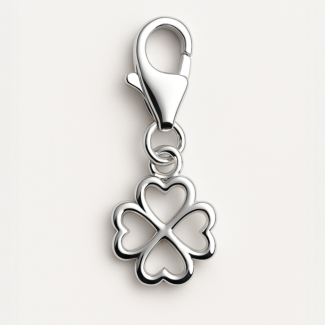 Silver four-leaf clover charm on a white background