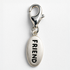 Silver charm with 'FRIEND' engraving on a white background