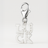 Silver 'LUCK' charm with a lobster clasp on a light gray background