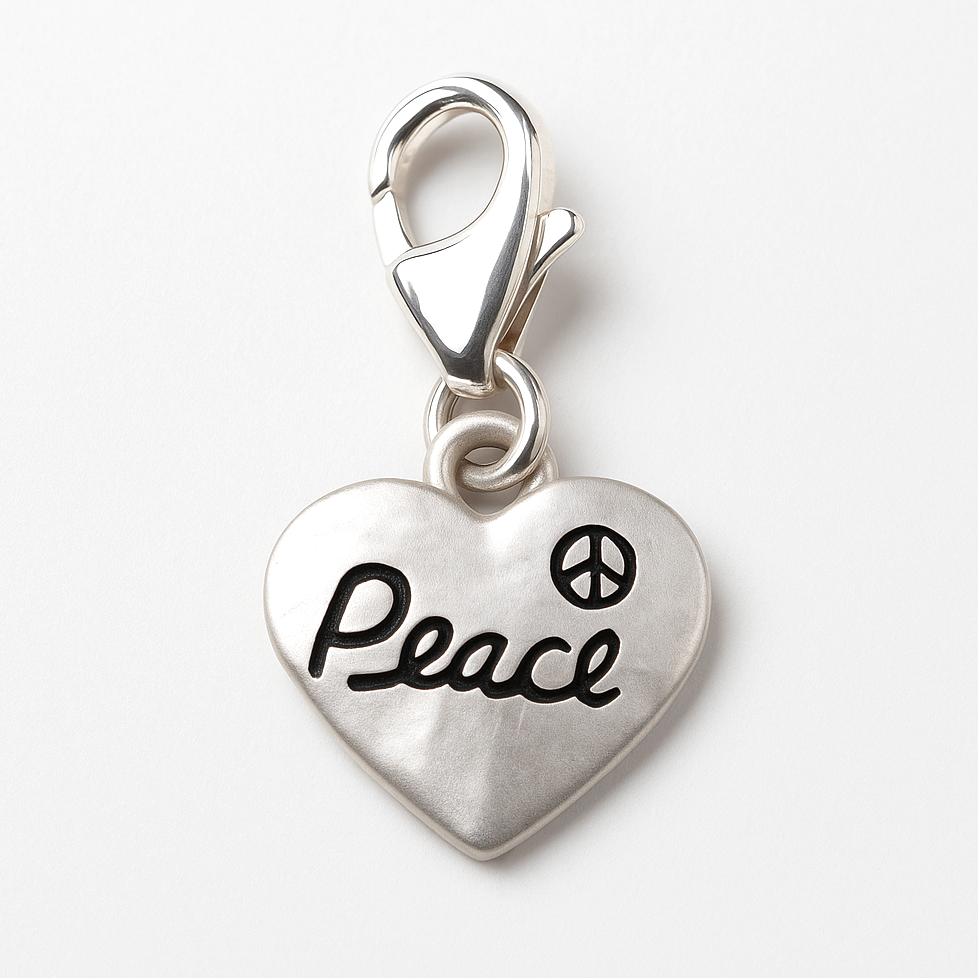 Silver heart-shaped charm with 'Peace' and peace symbol on a white background
