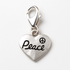 Silver heart-shaped charm with 'Peace' and peace symbol on a white background