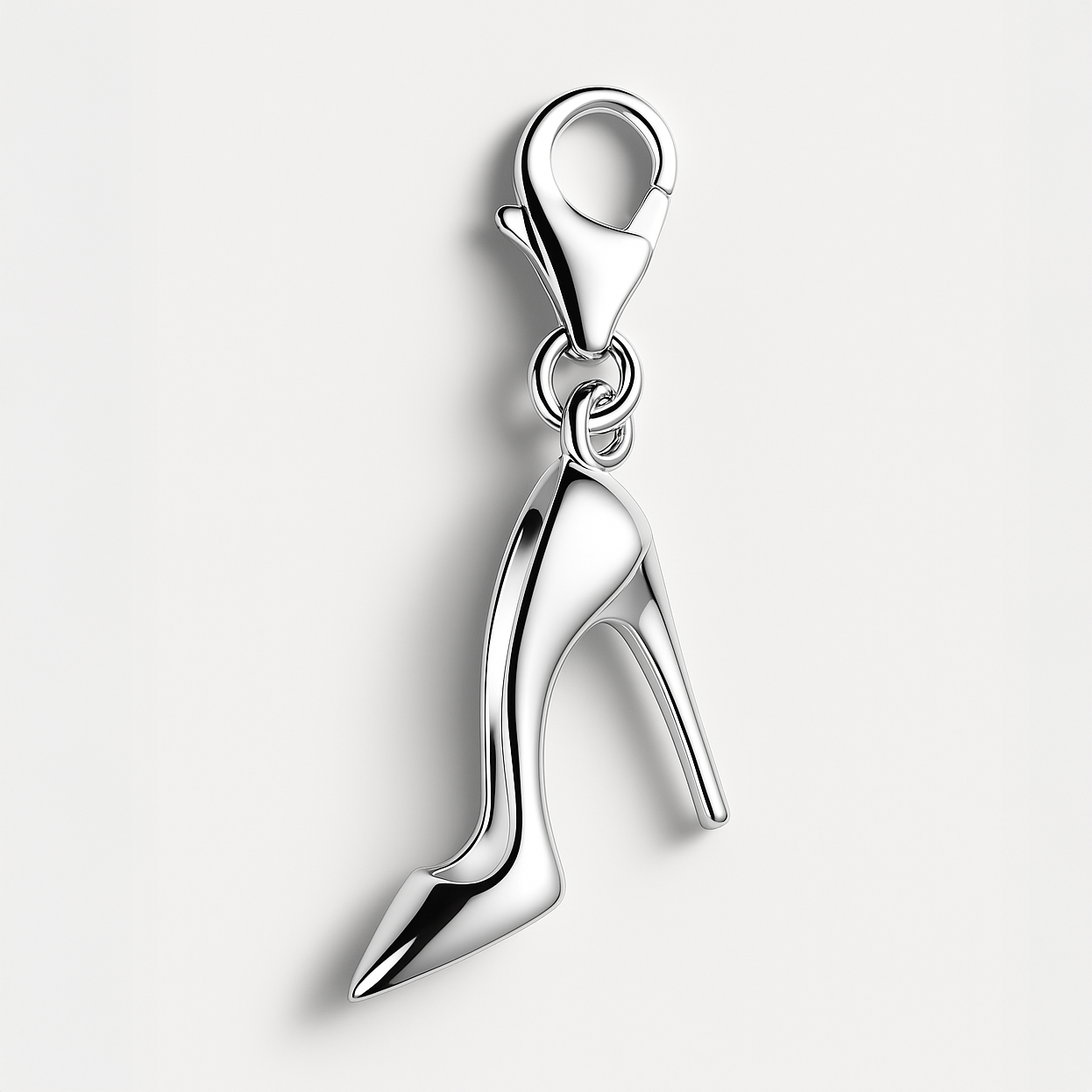 Silver high heeled shoe charm on a white background