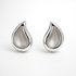 Pair of silver teardrop-shaped earrings on a white background