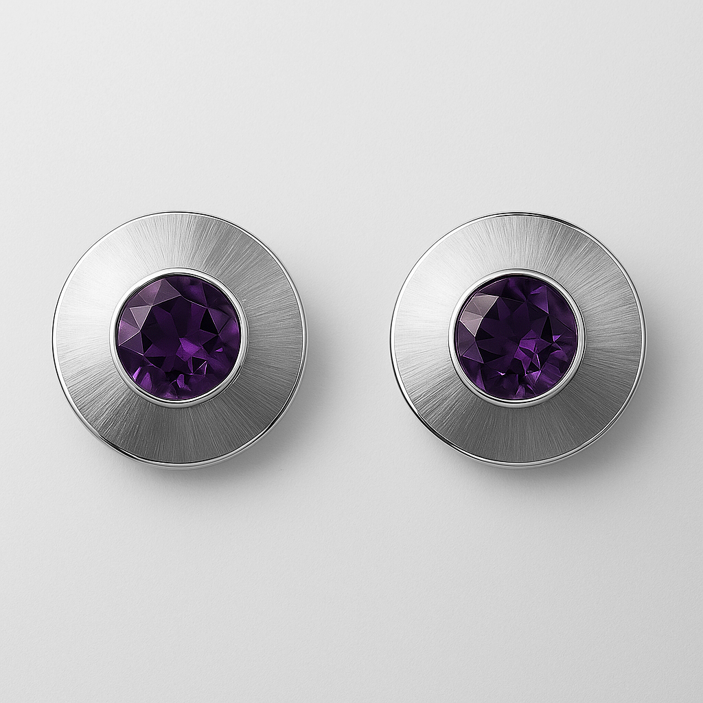 Pair of silver earrings with purple gemstones on a light grey background