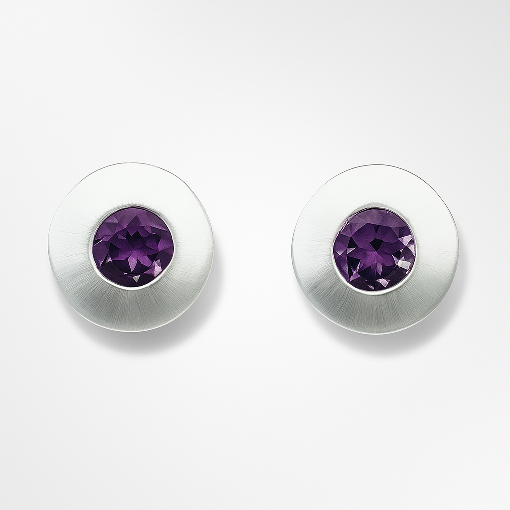 Pair of silver earrings with purple gemstones on a white background