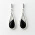 Teardrop-shaped earrings with black stones on a white background