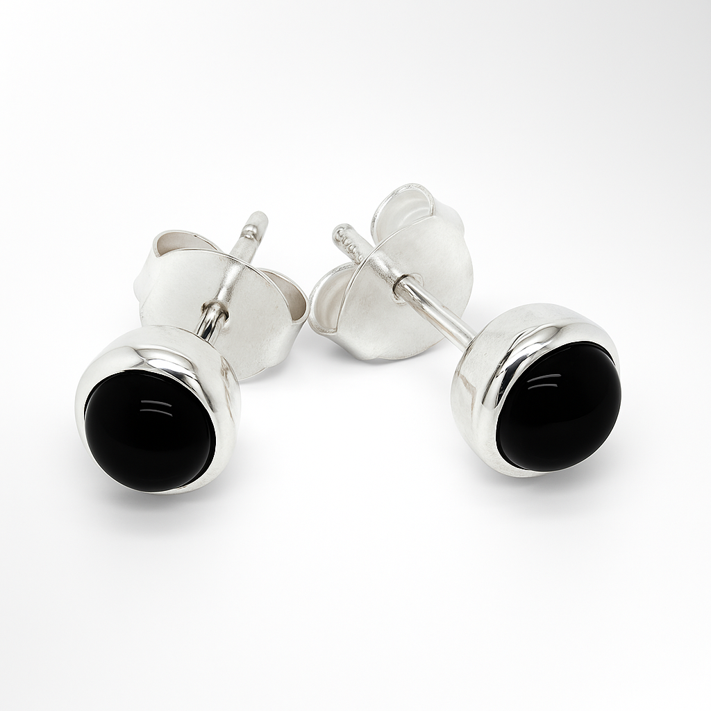 Silver stud earrings with black gemstones on a white background