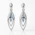 Silver earrings with blue gemstones on a white background