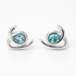 Silver earrings with blue gemstones on a white background