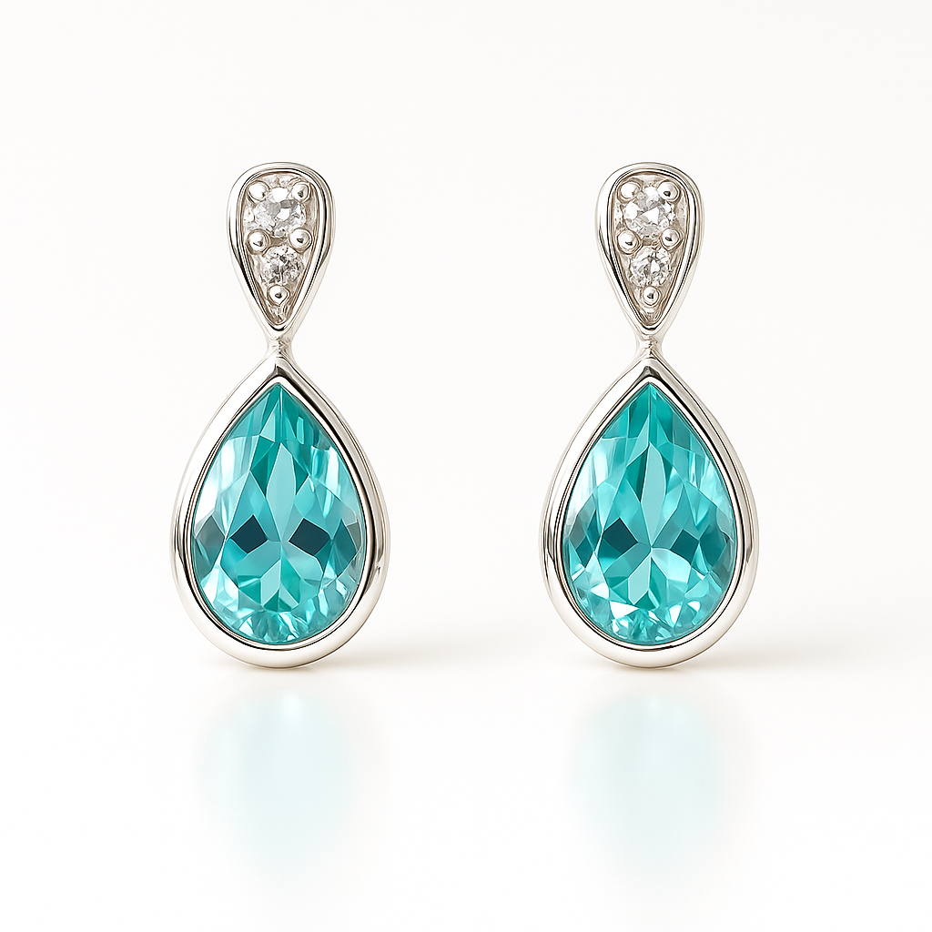 Teardrop-shaped blue topaz earrings with silver detailing on a white background