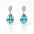 Teardrop-shaped blue topaz earrings with silver detailing on a white background