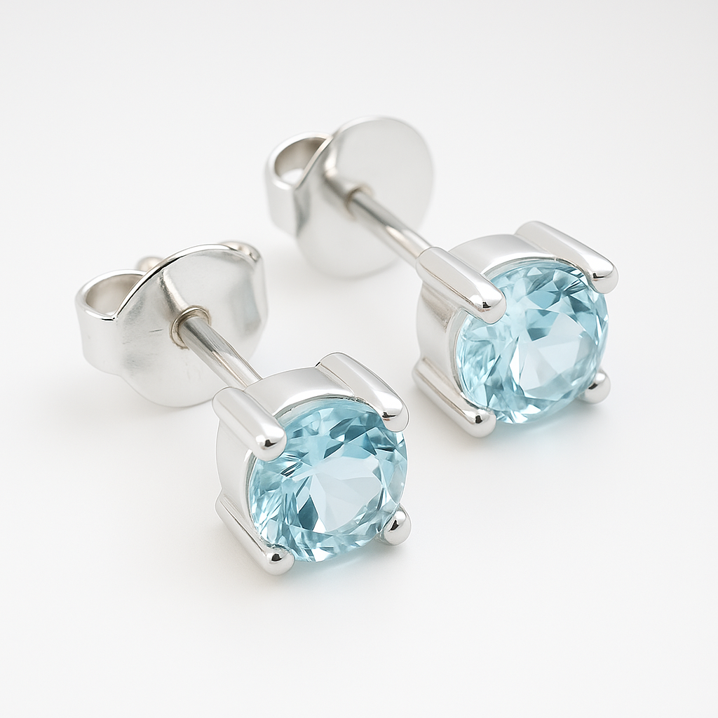 Pair of silver stud earrings with blue gemstones on a white background