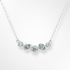 Silver necklace with blue and white gemstones on a white background
