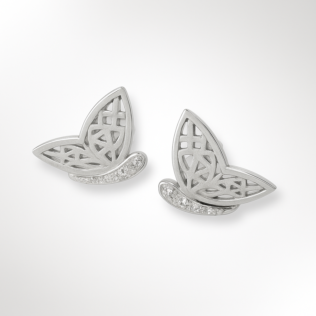 Butterfly-shaped silver earrings with intricate designs on a white background