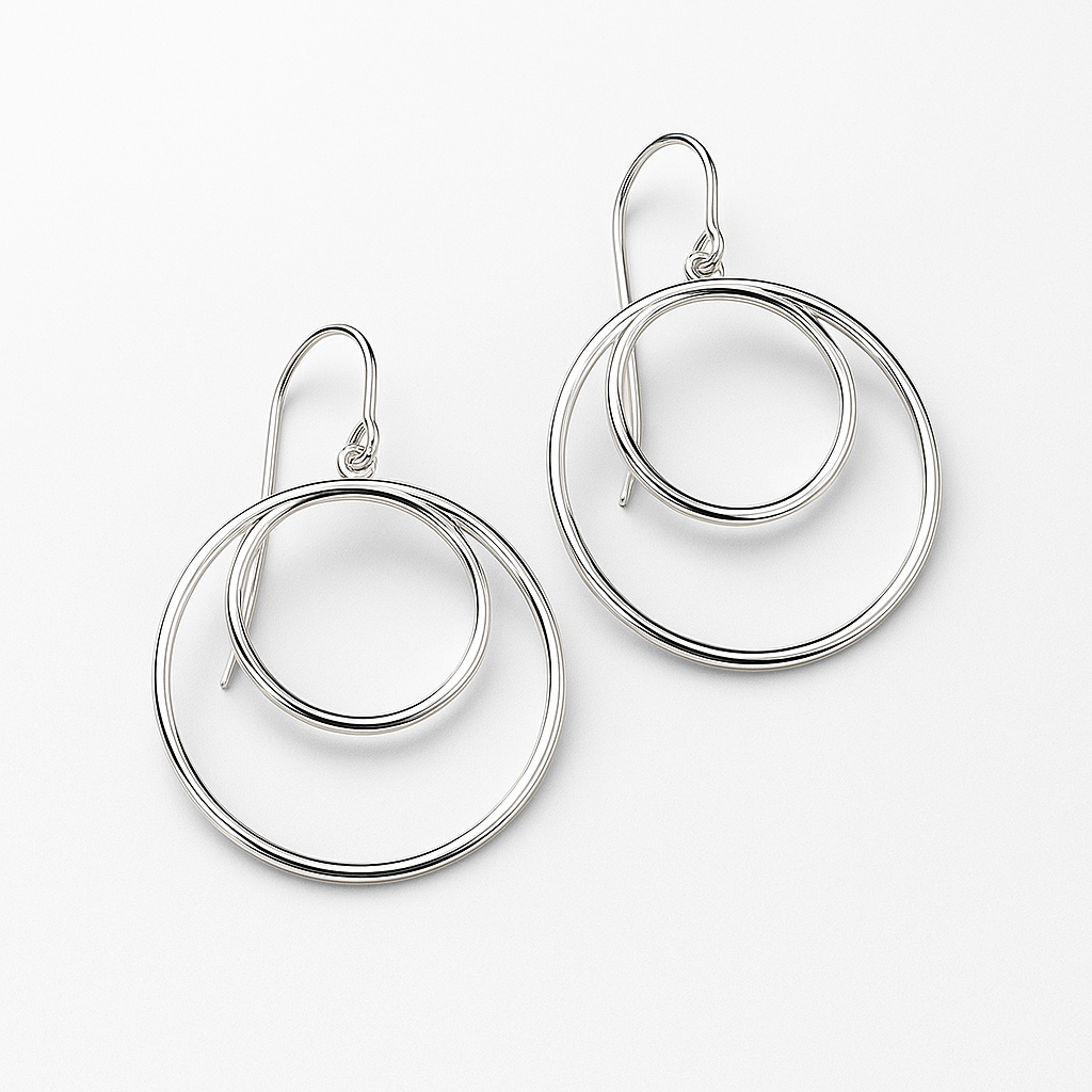 Pair of silver hoop earrings on a white background