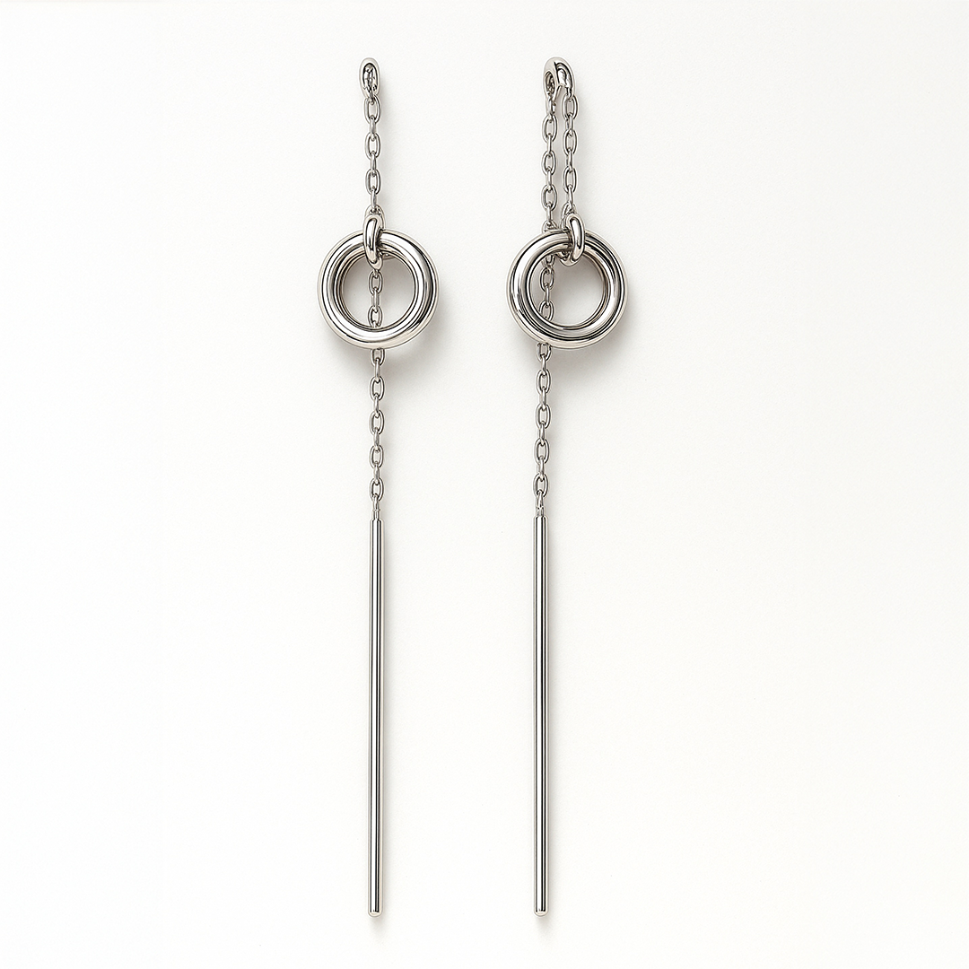 Pair of silver earrings with circular designs on a white background