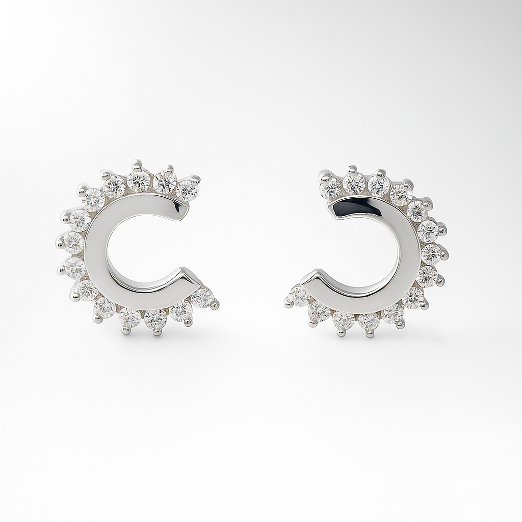 Pair of silver earrings with cubic zirconia accents on a white background