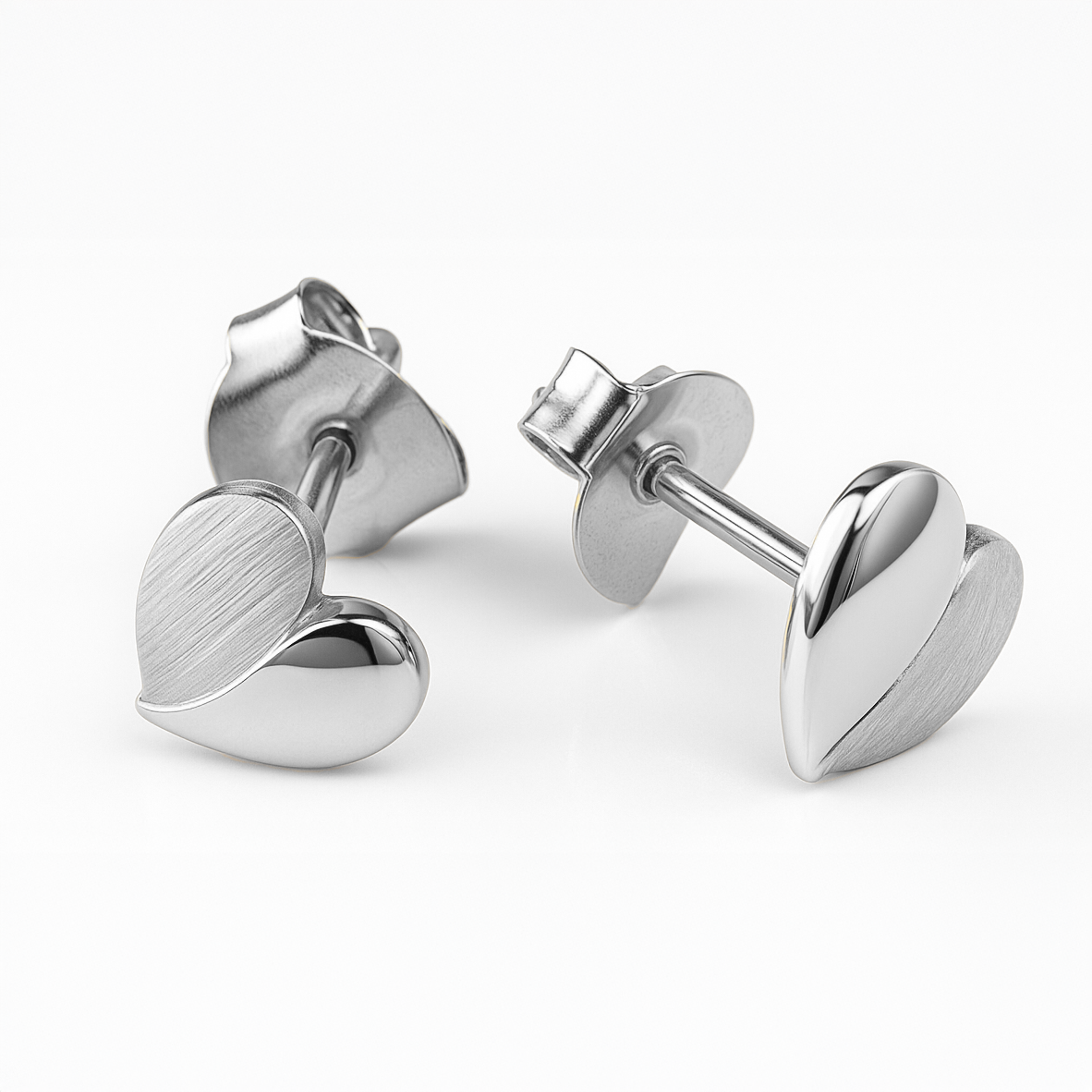 Pair of silver heart-shaped earrings on a white background