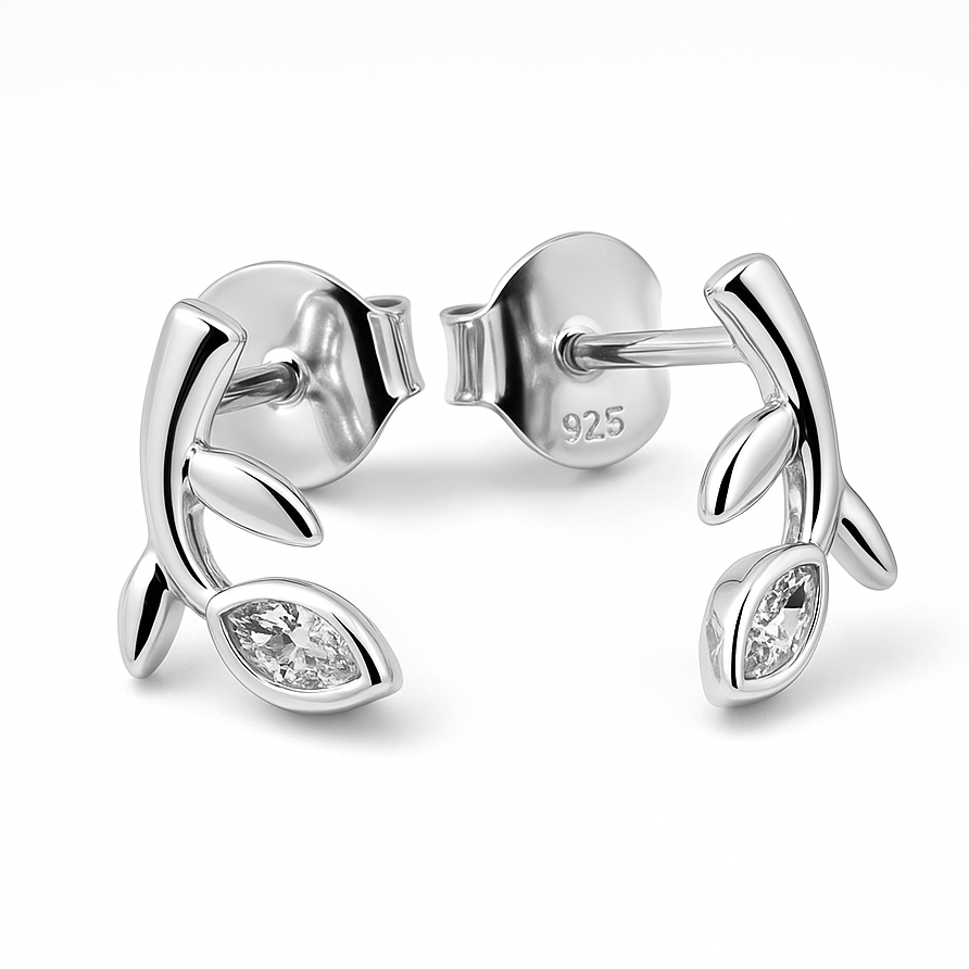 Silver earrings with leaf design and clear gemstones on a white background